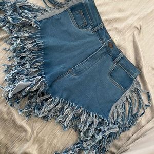 Never worn denim shorts with fringe
